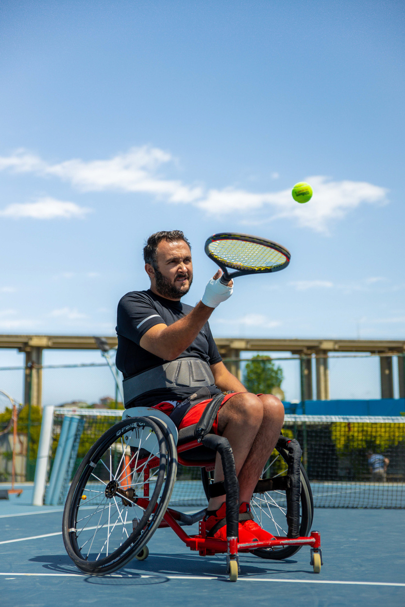 Adult Male Paralympian Playing Tennis Outdoors